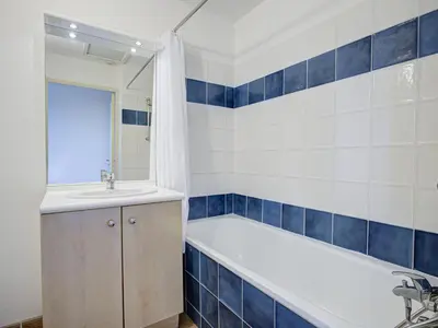 a bathroom with a bath tub and a sink at P Minervois P N05 Villa 2P4 in Homps