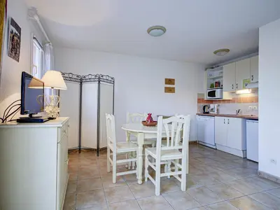 a kitchen with a table and chairs in a kitchen at P Minervois P N05 Villa 2P4 in Homps