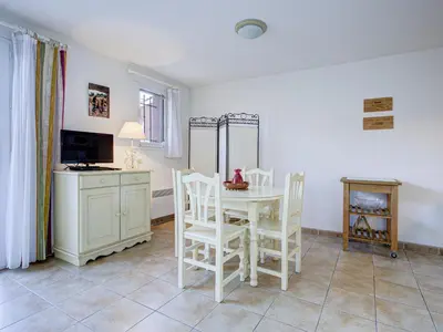 a dining room with a white table and chairs at P Minervois P N05 Villa 2P4 in Homps