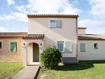 a large white house with green shutters at P Minervois G N02 Villa 3P4 in Homps