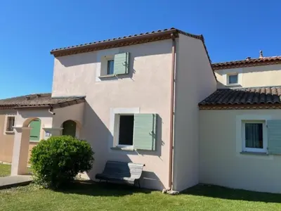 a large white house with green shutters on it at P Minervois G N02 Villa 3P4 in Homps