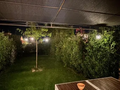 a garden at night with a table and some bushes at P Minervois G N02 Villa 3P4 in Homps