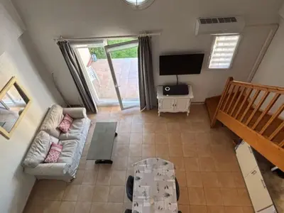 a living room with a couch and a tv at P Minervois G N02 Villa 3P4 in Homps