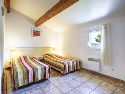two beds in a room with a window at P Minervois C N02 Villa 3P6 in Homps