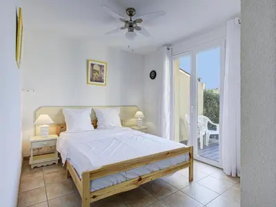 a bedroom with a bed and a balcony at P Minervois U N04 VILLA 3P6 in Homps