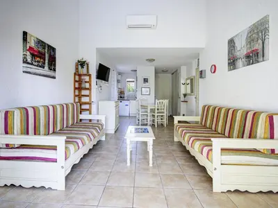 a living room with two couches and a kitchen at P Minervois U N04 VILLA 3P6 in Homps
