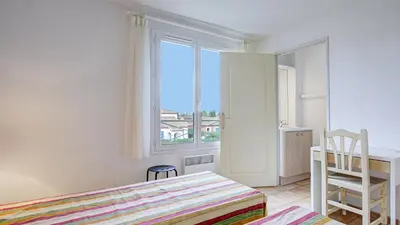 a kitchen with white cabinets and a white refrigerator at P Minervois I N01 Villa 4P8 in Homps