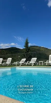 a picture of a swimming pool with chairs and a mountain at Écurie De Cucugnan in Cucugnan