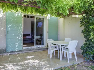 a table and chairs sitting on a patio at Haut du Lac I N205 3P6 in Homps