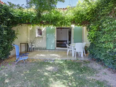 a patio with chairs and a table in a yard at Haut du Lac I N205 3P6 in Homps