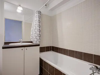 a bathroom with a bath tub and a sink at Haut du Lac I N205 3P6 in Homps