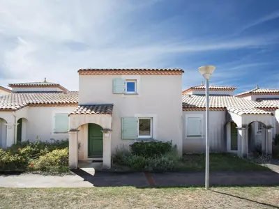 a white house with green doors and a street light at Haut du Lac I N205 3P6 in Homps