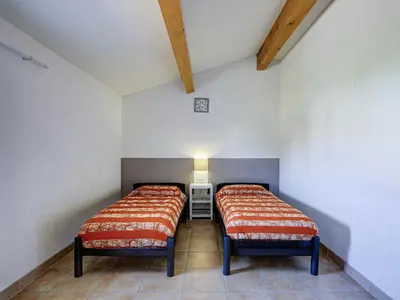 two beds in a room with white walls at Haut du Lac I N205 3P6 in Homps