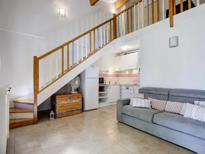 a living room with a couch and a staircase at Haut du Lac I N205 3P6 in Homps