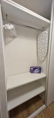 a white closet with a shelf and a purple box at La Romana in Narbonne