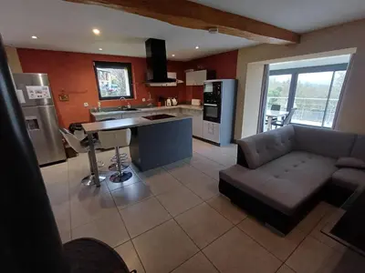 a living room with a couch and a kitchen at Lagrange in Leychert