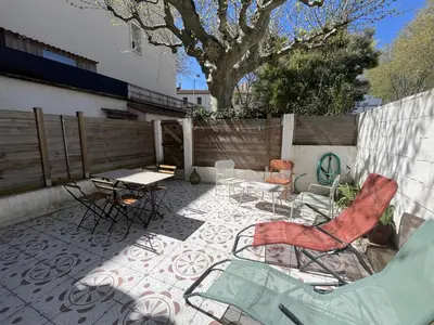 two chairs and a table on a patio at La terrasse du midi - Grande Terrasse - Proche centre-ville in Narbonne