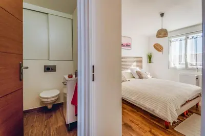 a small bedroom with a bed and a toilet at La douce echappee in Trèbes