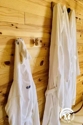a row of white towels hanging on a wall at La douce echappee in Trèbes