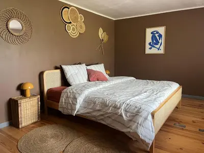 a bedroom with a bed and a mirror on the wall at Las Mijeannos in Cazalrenoux
