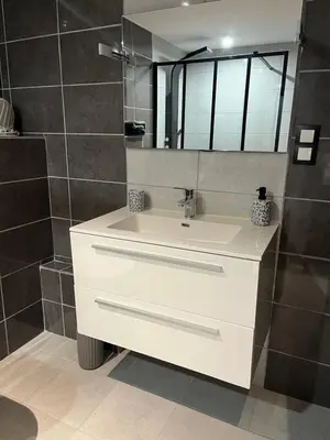 a bathroom with a white sink and a mirror at Las Mijeannos in Cazalrenoux