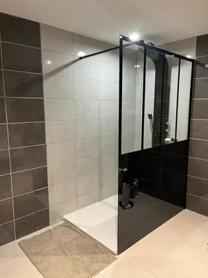 a shower with a glass door in a bathroom at Las Mijeannos in Cazalrenoux