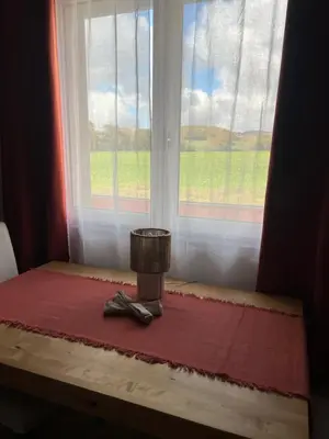a table with a window and a pair of scissors at Las Mijeannos in Cazalrenoux