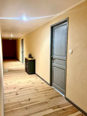 an empty room with a door and a wooden floor at Las Mijeannos in Cazalrenoux