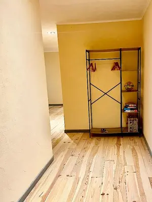 a room with a yellow wall and a wooden floor at Las Mijeannos in Cazalrenoux