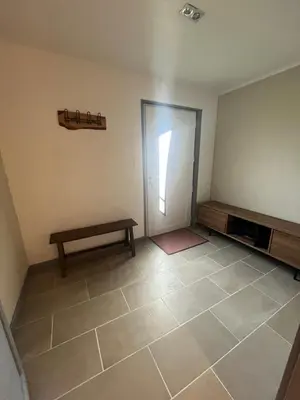 an empty room with a door and a bench at Las Mijeannos in Cazalrenoux