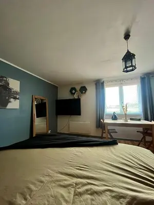 a bedroom with a large bed and a desk at Las Mijeannos in Cazalrenoux