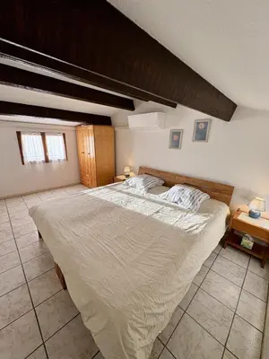a bedroom with a large bed in a room at Pavillon moderne & spacieux - accès direct plage in Gruissan