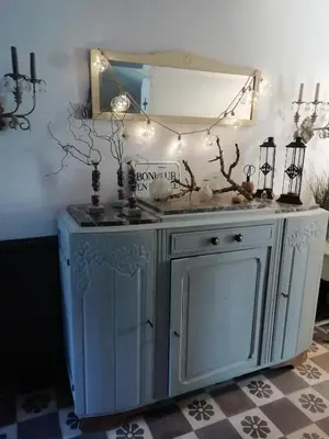 a blue cabinet with a mirror and lights on it at La maison de la fontaine in Villeneuve-Minervois