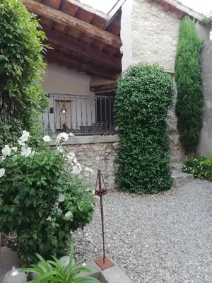 a garden with a fence and some bushes at La maison de la fontaine in Villeneuve-Minervois