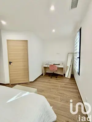 a bedroom with a bed and a desk and a door at Maison de ville - Les Grands Buffets in Narbonne