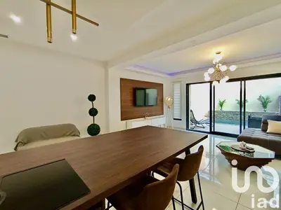 a living room with a dining table and a couch at Maison de ville - Les Grands Buffets in Narbonne