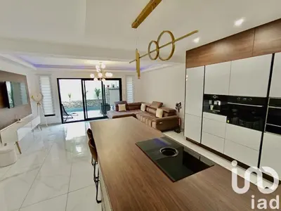 a kitchen and living room with a table and a couch at Maison de ville - Les Grands Buffets in Narbonne