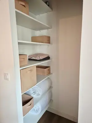 a walk in closet with boxes and towels at Appartement l'Atelier Cosy in Narbonne