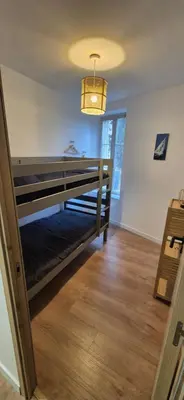 a room with a bunk bed with a light at Le Donjon du Chateau in Tournissan