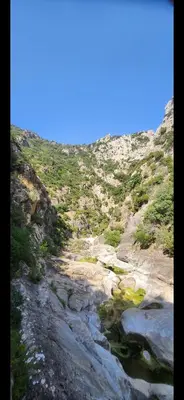a view of a rocky hillside with a river at Le Donjon du Chateau in Tournissan