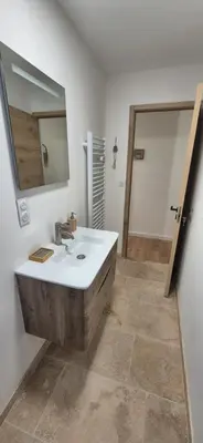 a bathroom with a sink and a mirror at Le Donjon du Chateau in Tournissan