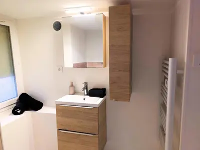 a bathroom with a sink and a mirror at Le Cocon de Pezens - Studio au centre du village in Pezens