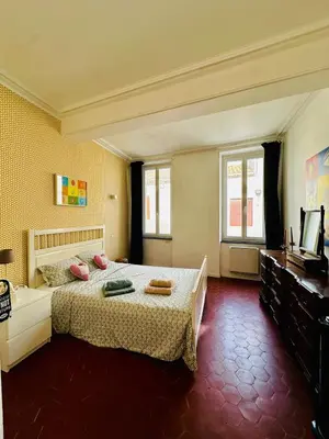 a bedroom with a bed and a television in it at Maison de village avec piscine 8 personnes in Ouveillan