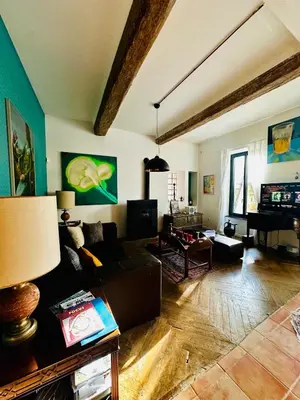 a living room with a couch and a piano at Maison de village avec piscine 8 personnes in Ouveillan