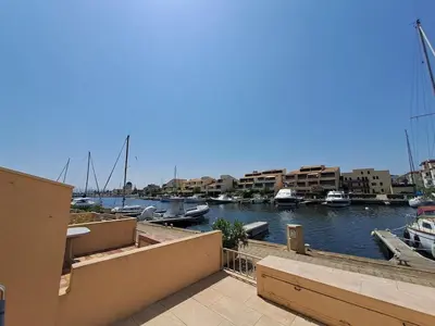 a view of a marina with boats in the water at Marina au bord de l'eau accès direct port in Gruissan