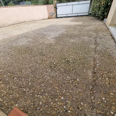 two trees in front of a concrete wall at villa familiale piscine privé sans vis à vis in Bages