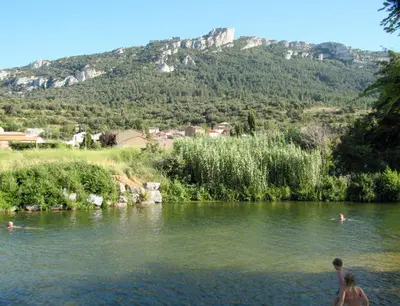 a man and a woman standing in a river at Gite La Grange, climatisée, vue sur le château de Peyrepertuse in Rouffiac-des-Corbières