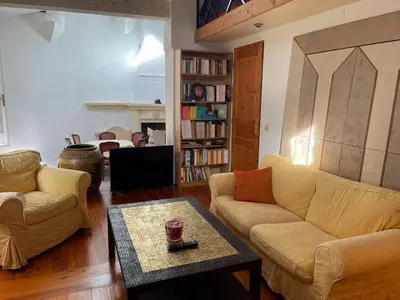 a living room with two couches and a coffee table at Small artist's house I Petite maison d'artiste in Saint-Michel-de-Lanès