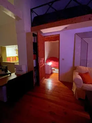 a room with a bedroom with a bunk bed and a room with a bed sqor at Small artist's house I Petite maison d'artiste in Saint-Michel-de-Lanès