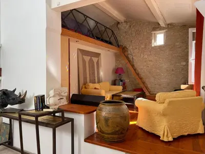 a living room with yellow chairs and a staircase at Small artist's house I Petite maison d'artiste in Saint-Michel-de-Lanès